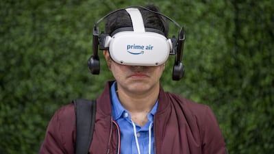 A person watches a Virtual Reality presentation about Amazon's Prime Air drone delivery, in the 'Neighbourhood of the Near Future' exhibit, during the Delivering the Future event at the Amazon Robotics Innovation Hub, in Massachusetts. Bloomberg