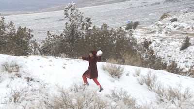 A girl throws a snowball in Ziarat, Pakistan, on Saturday during a trip to the snow-covered mountains with her family. Reuters