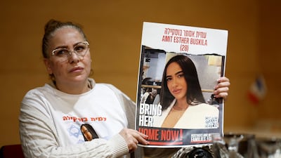 Mother of hostage Amit Esther Buskila holds a poster of her daughter during a press conference in Paris with representatives of families of French hostages held by Hamas. Reuters