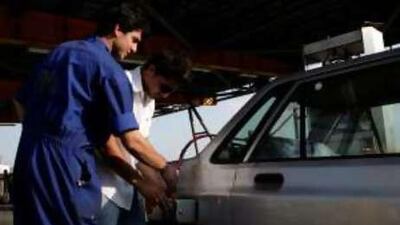 Iranians filling a car in Tehran. The oil-producing country has imposed gas rations of 120 litres per month because it lacks refiners.