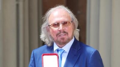 Barry Gibb poses after being knighted by Prince Charles at Buckingham Palace. Reuters