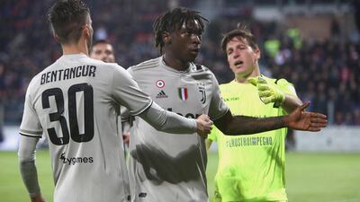 Moise Kean, centre, reacts to Cagliari fans after scoring for Juventus. He had been the victim of racist chanting throughout the game. Getty