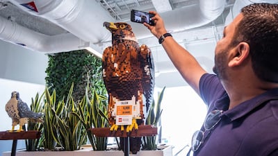 A visitor taking shot of an eagle made of Lego. Leslie Pableo for The National