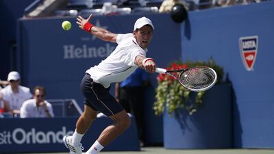 Novak Djokovic of Serbia reaches for a return against Kei Nishikori in a rally. Mike Segar / Reuters