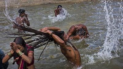 Hindu devotes take a bath in the Godavari river in Nasik, India, during Kumbh Mela. Bernat Armangue/AP Photo