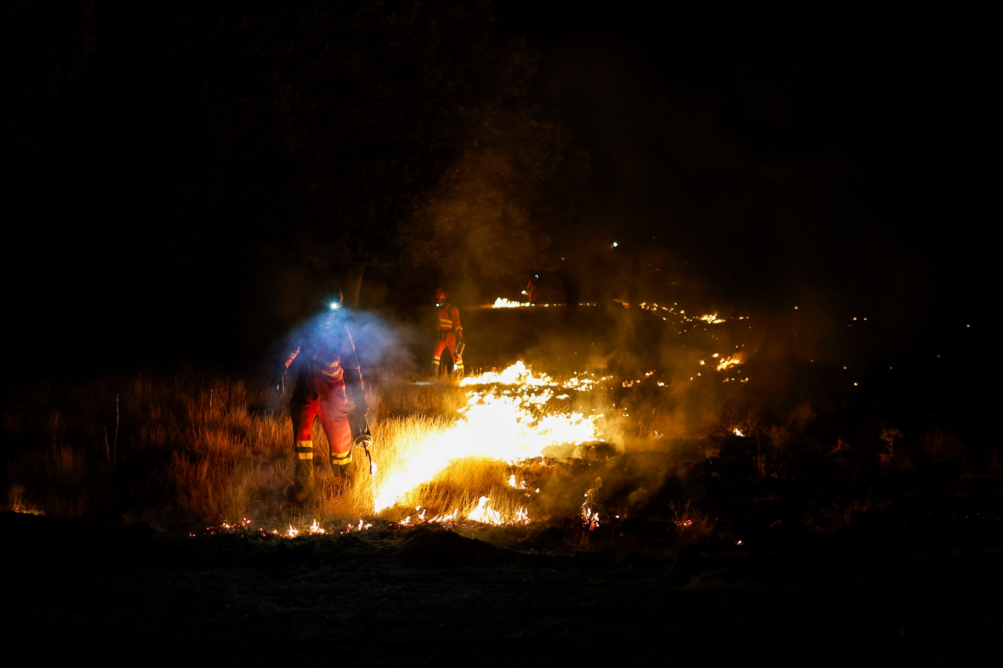 Firefighters racing to contain wildfires in Madrid, Spain, during a summer heatwave. Getty Images