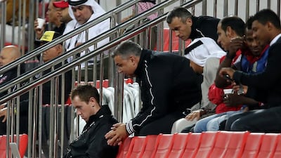 Chris Loxston, left, Al Ahli’s head of performance analysis, is busy in front of his computer even as a game is underway at the Rashid Stadium, Dubai. The Ahli coach Cosmin Olaroiu, second from left, then uses that information to devise strategies for the team. Pawan Singh / The National