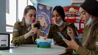 Three Israeli soldiers enjoy ice-cream at a shop inside the Ben & Jerry's factory in Be'er Tuvia in southern Israel, on July 21. AFP