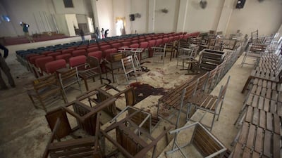 Chairs are upturned and blood stains the floor at the Army Public School auditorium the day after Taliban gunmen stormed the school in Peshawar on December 17, 2014. BK Bangash / AP Photo