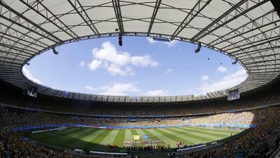 The national football teams of Colombia and Greece gather on the field to sing the national anthem before their 2014 World Cup Group C match in Belo Horizonte, Brazil on Saturday. Leonhard Foeger / Reuters