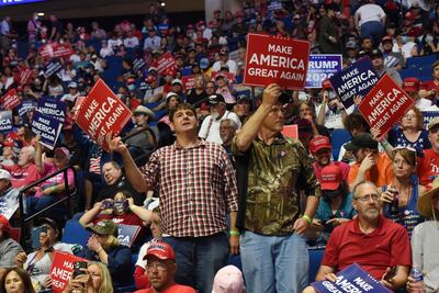 Supporters of US President Donald Trump hold placards during a rally inside the Bank of Oklahoma Centre in Tulsa, Oklahoma. EPA