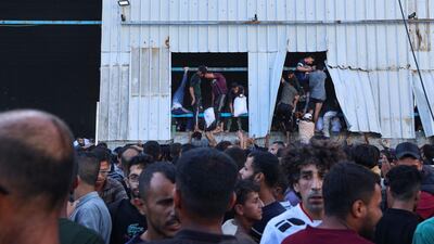 Displaced Palestinians carry bags of food aid after Israel allowed supplies in at a trickle last week. AFP