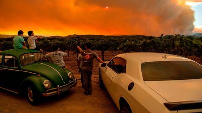 People watch the Walbridge fire in Healdsburg, California. AFP