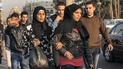 Two young women are harassed by group of men on Qasr el Nil bridge in Cairo. 'Our Women on the Ground' highlights issues facing women in places such as the Egyptian city. Courtesy Eman Helal