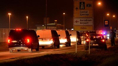 Bosnian nationals from Syria travelling under heavy security leave the airport in Sarajevo on Thursday. AP