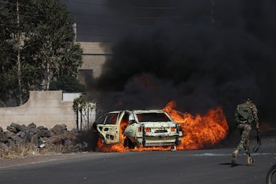 A burning car during the fighting near Sweida in July. Getty Images