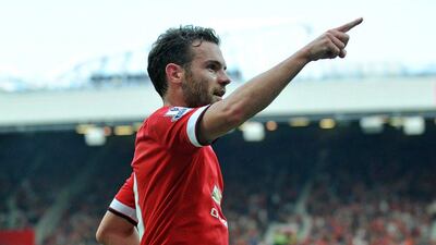 Manchester United's Juan Mata celebrates scoring their fourth goal in a 4-0 win over QPR in the EPL on Sunday. Paul Ellis/ AFP