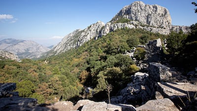 The ancient city of Termessos was built at an altitude of more than 1,000 metres on Mount Solymos, in the modern-day Turkish province of Antalya. Here is a view of the upper city wall on the right and the Pamphylian plain beyond. Charlotte Mayhew / The National