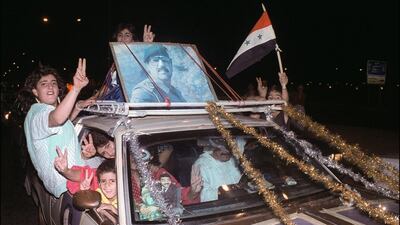 Baghdad residents celebrate the end of the eight year Iran-Iraq War in August 1988. Marcel Mochet / AFP