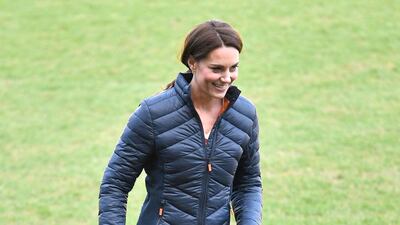 To play football at a visit to the Irish Football Association at Windsor Park Stadium in Belfast, the duchess wears a quilted Barbour jacket, black jeans and blue New Balance trainers. EPA