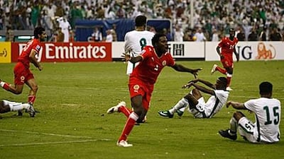 Ismail Abdullatif, centre, celebrates helping his country progress to the play-offs as the Saudi players around him drop to the floor in dejection.
