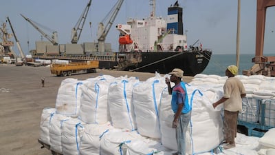 Yemenis receive sacks of food aid packages from the World Food Programme in the port city of Hodeidah in June. AFP