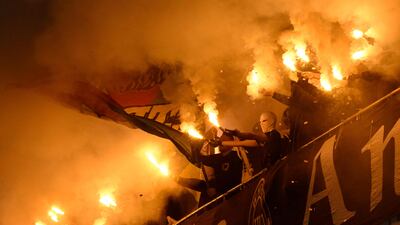 Vitoria Guimaraes's fans burn flares during the Portuguese League football match between Vitoria Guimaraes SC and SL Benfica at Dom Afonso Henriques stadium in Guimaraes. AFP