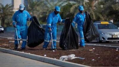 Cleaners hard at work along the Corniche Road in Abu Dhabi.