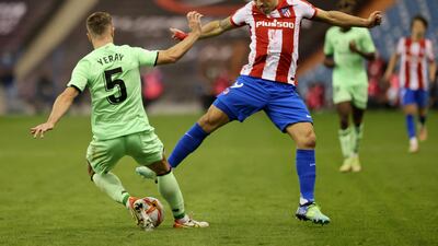 Athletic Bilbao's Yeray Alvarez dives in to tackle Atletico Madrid's Luis Suarez. Reuters