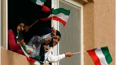 Flying the flag: Kuwaiti citizens are being given 1,000 dinars each to mark the emirate's national and liberation days and the anniversary of its emir coming to power.