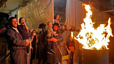 Ultra-Orthodox Jews light a Lag BaOmer bonfire in Jerusalem's religious Mea Shearim neighbourhood amid an Israeli health ministry's order to maintain social distancing and to cancel all holiday celebrations. AFP