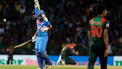 India's Dinesh Karthik, left, celebrates scoring the winning run to defeat Bangladesh by four wickets in Colombo. Eranga Jayawardena / AP Photo