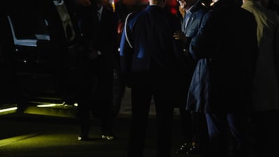 Mr Biden with other US officials at the airport. AP