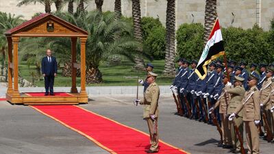 President Barham Salih reviews an honour guards during a handover ceremony at the Iraqi presidential palace. EPA