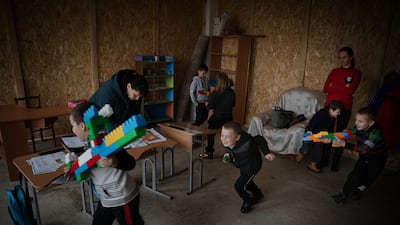 Classmates play with rifles made from Lego blocks after school, in Vysokopillya, December 2023. Getty Images