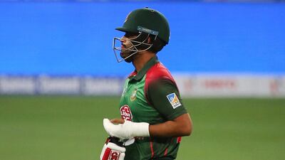Bangladesh's Tamim Iqbal with his injured left hand covered in an orthopedic cast leaves the field at the end of first innings during the one day international cricket match of Asia Cup between Sri Lanka and Bangladesh in Dubai, United Arab Emirates, Saturday, Sept. 15, 2018. (AP Photo/Aijaz Rahi)