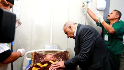 Iraqi Prime Minister Adel Abdel Mahdi visits the people who survived the disaster. EPA