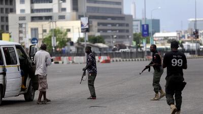 Police officers stop and search a bus carrying passengers around Lekki toll gate in Lagos Friday. AP
