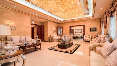 Grand chandeliers in the formal living room. Photo: Engel and Voelkers