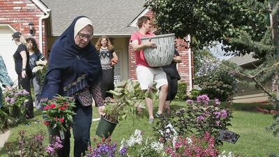 Friends and neighbours of Khalid Jabara create a memorial outside the Jabara family home. Sue Ogrocki / AP
