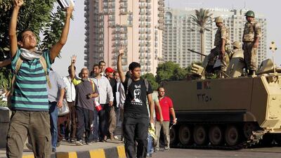 Supporters of Mohammed Morsi flash the Rabaa symbol as they demonstrate in Cairo on Friday. AFP