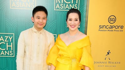 Actress Kris Aquino in a traditional-Filipina-inspired gown by Michael Levya, with her son Bimby Aquino Yap. AFP