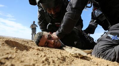 Israeli security forces detain a Bedouin man during a protest against forestation at the Negev desert village of Sawe al-Atrash, southern Israel January 12, 2022. REUTERS / Ammar Awad TPX IMAGES OF THE DAY