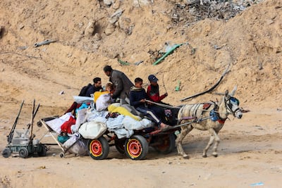 Palestinians transport their belongings on a donkey-drawn cart as they travel to Jabalia. AFP