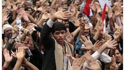 Anti-government protesters shout slogans during a rally to demand the departure of Yemen's President Ali Abdullah Saleh at Tahrir Square in Sana'a yesterday.