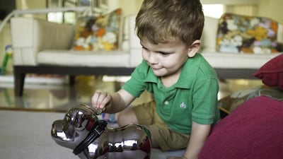 Dubai tot Alfie Edwards is learning lessons about saving money. Leo Edwards