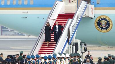 US president Donald Trump and first lady Melania Trump descend from Air Force One as they arrive in Beijing. Lintao Zhang / AFP Photo