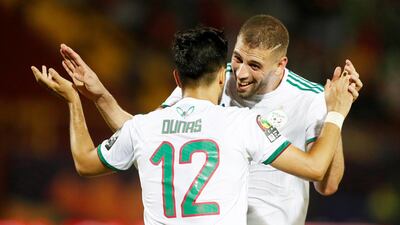 Algeria's Adam Ounas celebrates scoring their second goal with Islam Slimani, who scored Algeria's other two goals in a 3-0 victory over Tanzania on Monday. Reuters