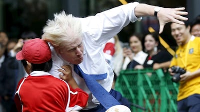 London’s Mayor Boris Johnson collides with 10-year-old Toki Sekiguchi during a game of Street Rugby in Tokyo. Issei Kato / Reuters