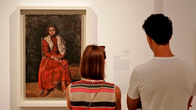 Visitors observe 'The Barefoot Girl' (1895), an earlier work by Picasso before the artist moved to Paris and developed Cubism. Joseph Eid / AFP